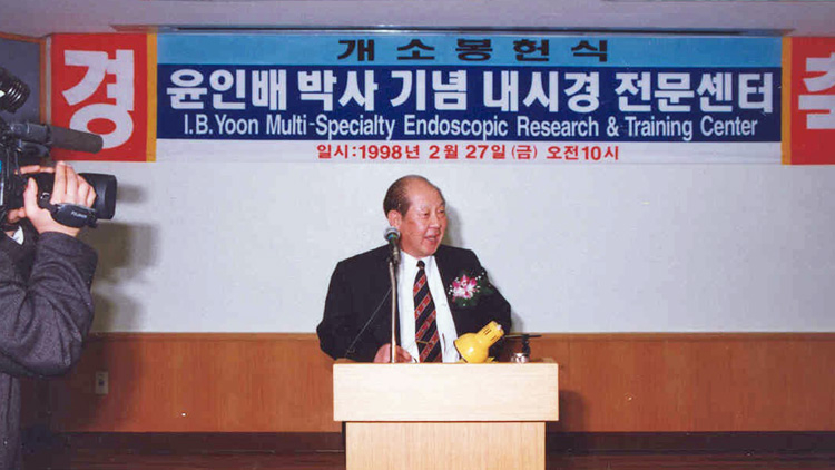 Dr, Yoon speaking at a podium