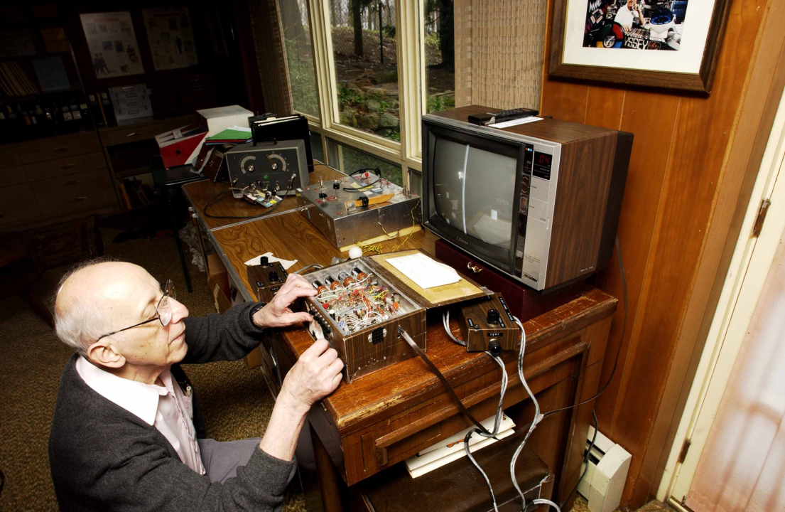 Ralph Baer kneeling at Brown Box console