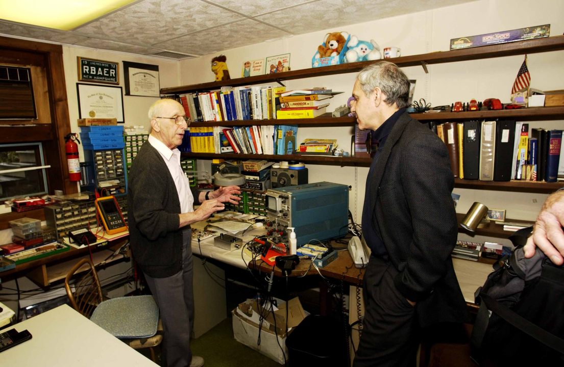 Video game inventor Ralph Baer shows Lemelson Center Director Art Molella his basement workshop.