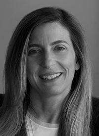 Professional headshot of a white woman with long hair.