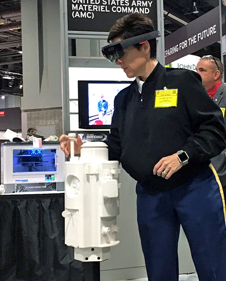 Servicewoman trying out augmented reality with Hololens in a trade fair setting