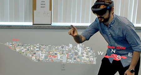 Researcher interacting with a 3-D augmented reality model of a city