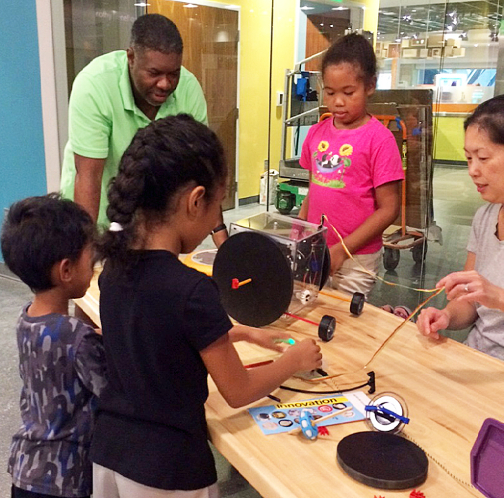 Family at gyroscope activity