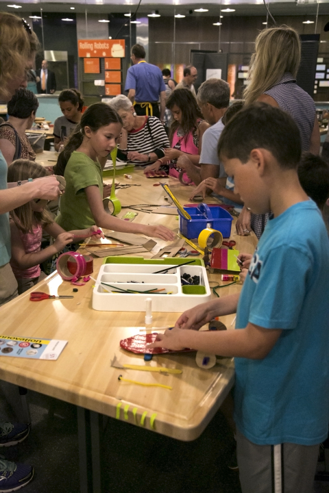 Children and families invent using recyclable materials in Spark!Lab