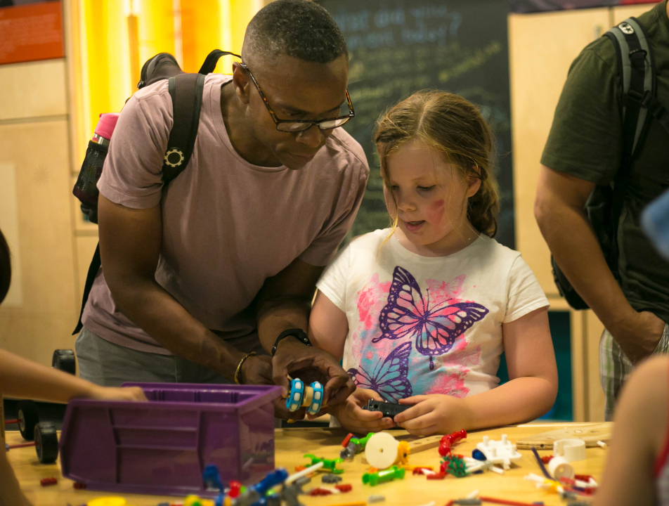 A father and daughter work on a project in Spark!Lab