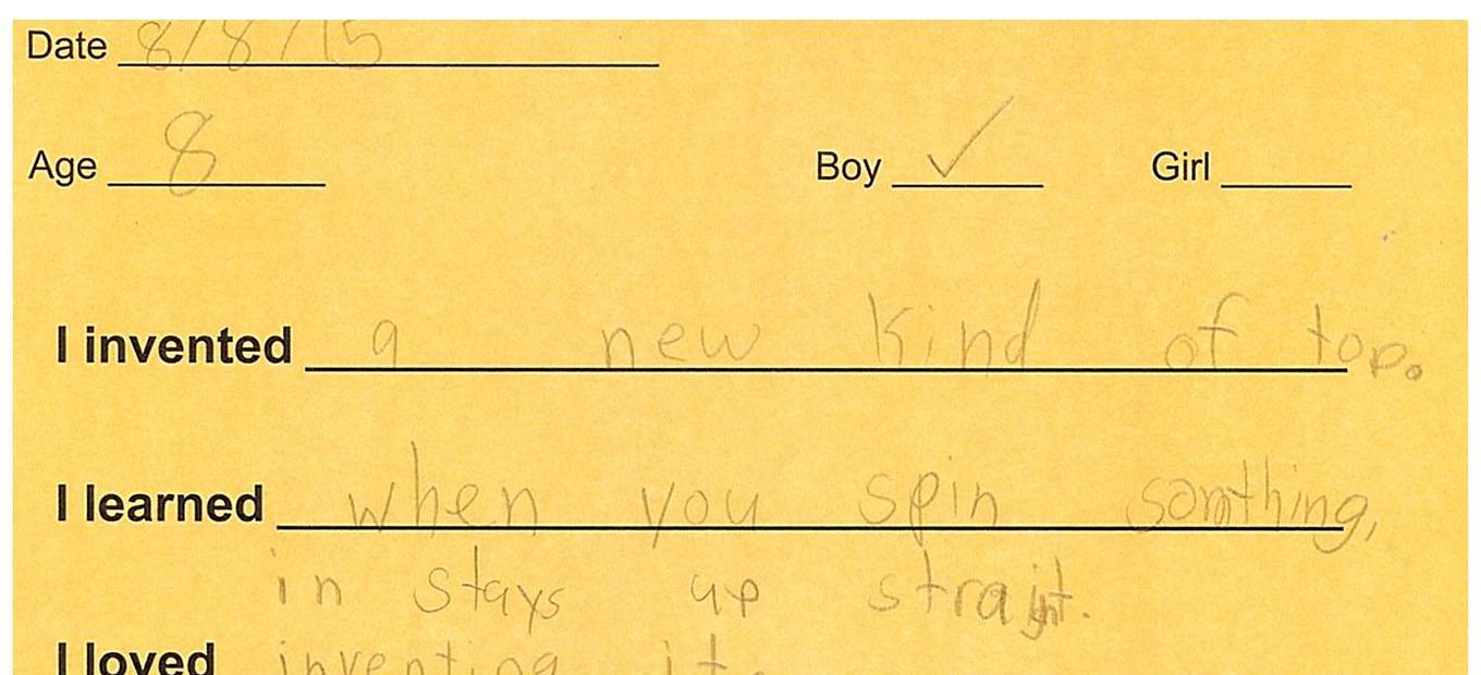 A yellow comment card completed by an eight year old Spark Lab visitor. The card prompts the visitor to fill out responses to what they invented, what they learned, what they loved, and what they didn't like. This visitor invented a new kind of top, learned that when they spin something it stays up straight, they loved inventing it, and they didn't like all the work.