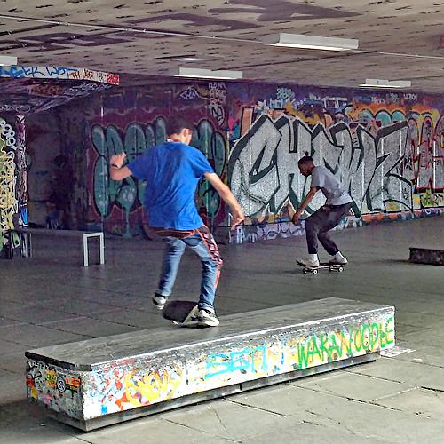 2 skateboards performing tricks