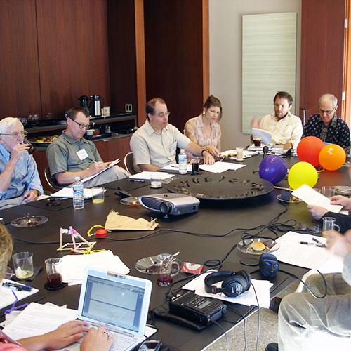 A group of people seated around a large conference table